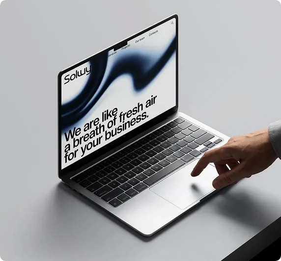 Freelance UI UX designer navigating responsive client web portfolio on modern slim laptop